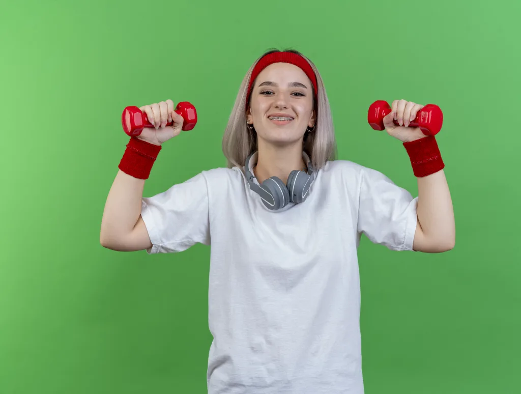 A person performing dumbbell thrusters, a full-body conditioning exercise included in dumbbell workouts for maximum calorie burn.