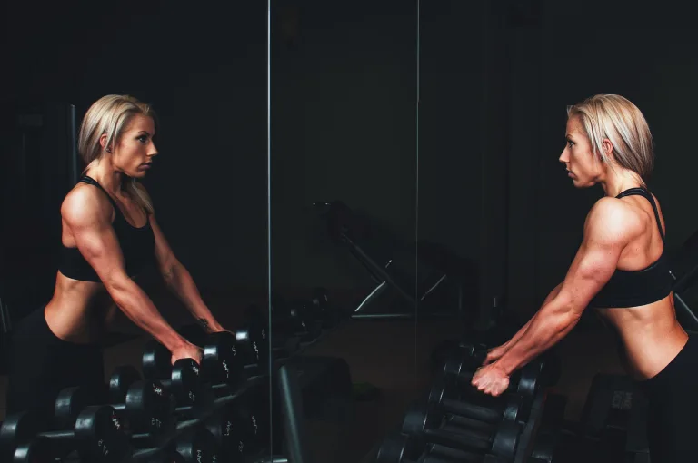 Athlete performing explosive dumbbell training for power and strength.